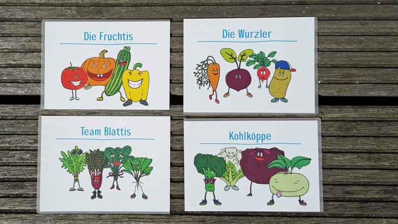 4 Karten mit Zeichnungen von Gemüse und Teamnamen